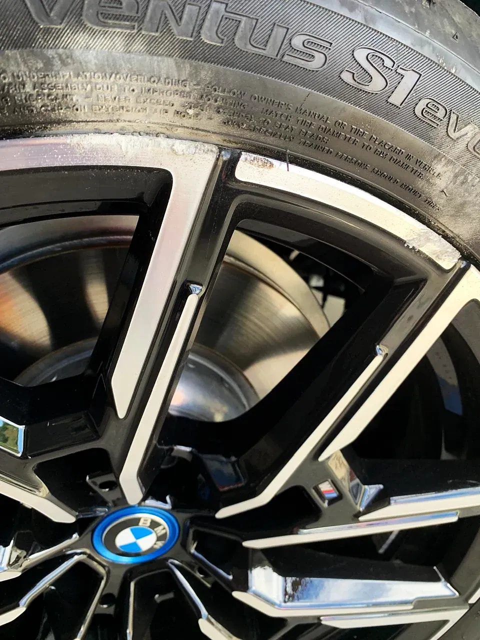Roda BMW diamantada em detalhe, com raios pretos e faces usinadas